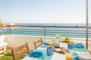 a table with a plate of food on a balcony at Marlicante in Alicante