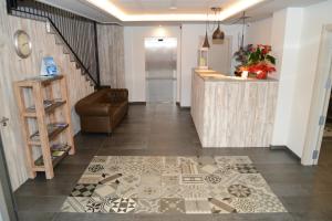 a hallway with a staircase and a lobby with a counter at Hotel L'Escala Centre in L'Escala