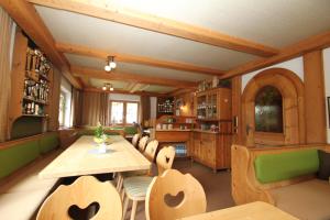 a dining room with a table and chairs at Rimmlhof & Rimmlstube in Berwang