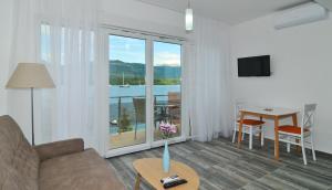 a living room with a couch and a table at Apartments Edera in Tivat