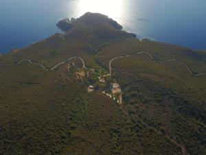 an aerial view of a hill with a house on it at Auberge Ferayola in Galeria