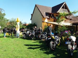 a group of motorcycles parked in front of a house at Casa Ardeleneasca in Sebeşu de Sus
