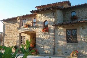 a stone building with flower boxes on the windows at Agriturismo Cioccoleta in Orvieto