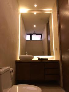 a bathroom with a sink and a mirror at Hotel Bohonito Holbox in Holbox Island