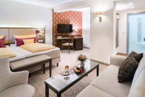 a hotel room with a bed and a couch at Schlosshotel Klaffenbach in Chemnitz +60 photos