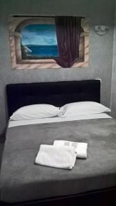 Un pat sau paturi într-o cameră la Maria Turistico