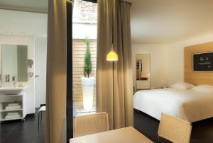 Posteľ alebo postele v izbe v ubytovaní Hotel Le Pavillon 7
