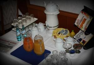 a table with glasses and drinks on it at Hotel Alina in Wiesbaden