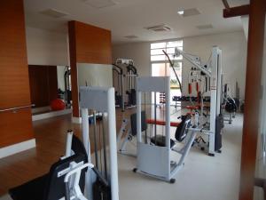 a gym with several tread machines in a room at Vista ao Mar & Lazer Total in Guarujá