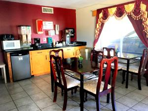 a kitchen with a table and chairs and a table and a kitchen with a kitchen at Executive Inn Express Delhi in Delhi