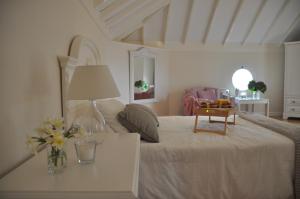 a bedroom with a bed and a table with flowers on it at Casita en Guamasa in Tacoronte