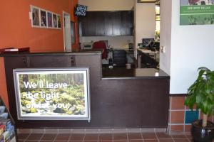 un mostrador de restaurante con un letrero que dice que deje la luz encendida en Motel 6 Oakdale, Ca, en Oakdale