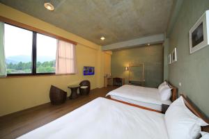 a hotel room with two beds and two windows at Country Living Home Stay in Jian