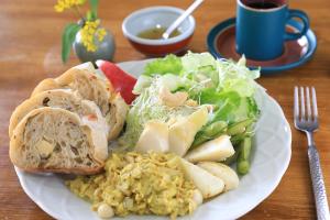 a white plate of food with a salad and bread at Country Living Home Stay in Jian