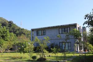 a house in the middle of a field with trees at Country Living Home Stay in Jian