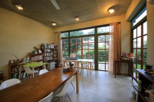 a room with a table and chairs and a large window at Country Living Home Stay in Jian