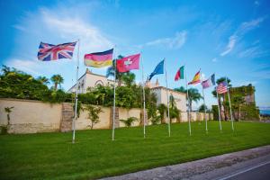 a bunch of flags flying in the grass at Sangiorgio Resort & Spa in Cutrofiano