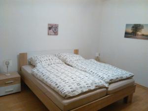 a bedroom with a bed with a white comforter on it at Mia und Michel im Sauerland in Bad Berleburg