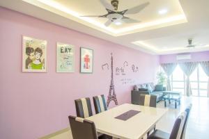 a dining room with a table and chairs at Lavender One Residence Apartment in Sekincan