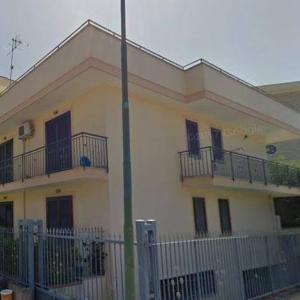 a white building with balconies and a fence at SWEET HOME GIULIA Locazione ad uso turistico in Cimitile