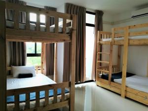 two bunk beds in a room with a window at Baan der Bruyn in Jomtien Beach +50 photos