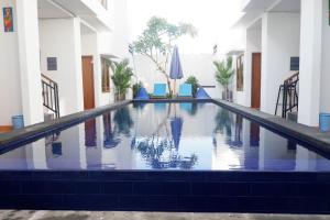 a swimming pool in the middle of a building at The Kayuri in Canggu +10 photos