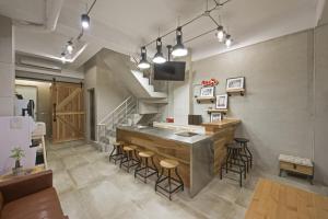 cocina con barra y taburetes en una habitación en OX Suites en Kaohsiung