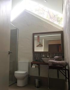 a bathroom with a sink and a toilet and a mirror at Dunsborough Ridge Retreat in Dunsborough