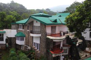 a group of buildings with green roofs at Velvet County Resort & Spa in Lonavala