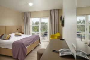 Uma cama ou camas num quarto em Hotel Hamar