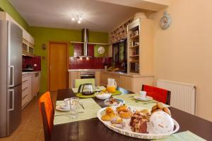 a kitchen with a table with a plate of food on it at Evalexia Villa in Kalamaki