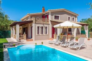 a villa with a swimming pool and a house at Evalexia Villa in Kalamaki