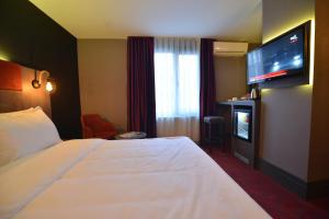 Postel nebo postele na pokoji v ubytování A11 Hotel