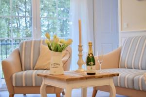 a table with two bottles of champagne and flowers on it at Villa Strandblick 5 in Zingst