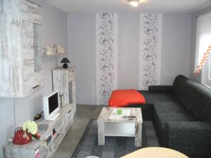 salon z kanapą i telewizorem w obiekcie Kleine Ferienwohnung w mieście Barth