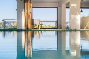 a pool of water with a chair in a building at Semeli in Kokkari