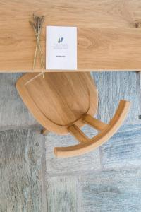 a wooden chair sitting on top of a table at Semeli in Kokkari