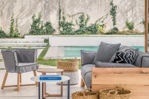 a living room with a couch and a chair at Semeli in Kokkari