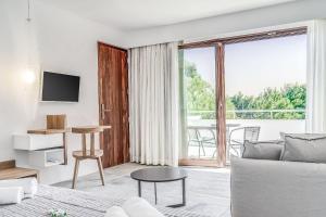 a living room with a couch and a large window at Semeli in Kokkari