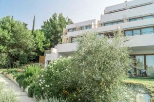 a white building with trees in front of it at Semeli in Kokkari