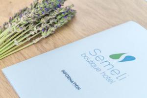 a piece of paper next to a bunch of lavender at Semeli in Kokkari