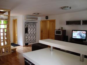 a living room with a white table and a tv at Apartment Jimmy - luxury 65m2 two bedrooms aprtmnt in Dubrovnik