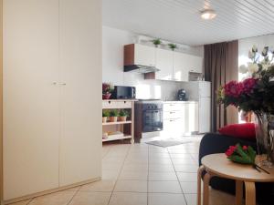 a kitchen with white cabinets and a table in a room at Como's Lake Mountains B&B in Cremeno