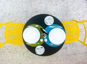 a table with two plates and a car on it at Semeli in Kokkari