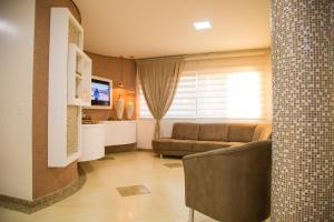 TV a/nebo společenská místnost v ubytování Dois Vizinhos Palace Hotel