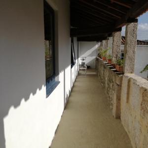 a hallway of a house with a table and chairs at Casa na Quinta de Valinhas in Vitorino dos Piães