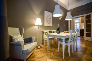 een eetkamer met een witte tafel en stoelen bij Logement Sous le Château in Boedapest