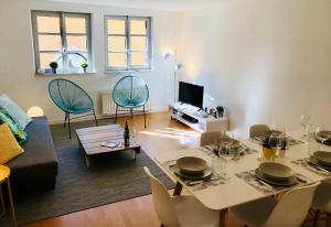 a living room with a table and a couch at MyAlsace in Colmar