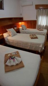 two beds in a hotel room with towels on them at Hotel Ideal in Montecarlo