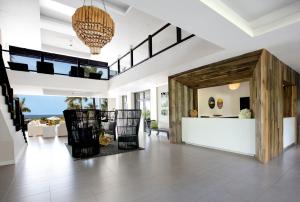 an open living room with a large wooden door at The Cliff Hotel in Negril